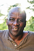 Cheerful senior African American man looking at the camera while standing outdoors
