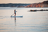 Woman paddleboarding at sea