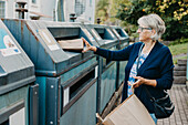 Woman recycling rubbish