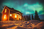 Aurora borealis over wooden house