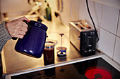 Woman preparing coffee in kitchen