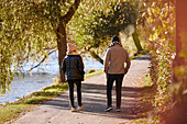 Man and woman walking in autumn park