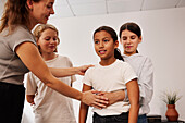 Teachers and children in first aid class