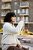 Young woman looking at herself in mirror