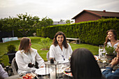 Friends having meal in garden