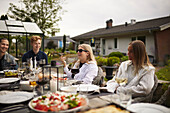 Friends having meal in garden