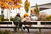 Man and woman sitting on bench