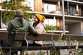 Man and woman sitting on bench