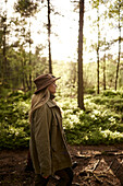 Woman walking through forest