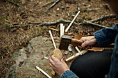 Hands with axe chopping wood