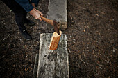 Person with axe chopping wood