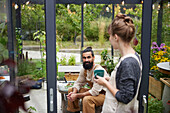 Friends talking in greenhouse