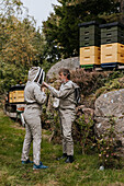 Beekeepers putting bee suits on