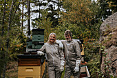 Beekeepers standing near beehive