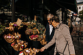 Senior couple choosing bouquet in flower shop