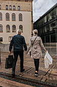 Couple walking in city with shopping bags