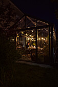 Illuminated greenhouse in garden