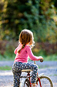 Girl on old-fashioned bicycle