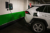 Electric car getting charged in garage