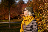 Portrait of senior woman in autumn scenery