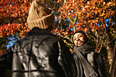 Smiling man talking to friend