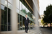 Businessman walking while talking via cell phone