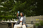 Woman in garden taking selfie