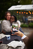 Person taking photo of two female friends