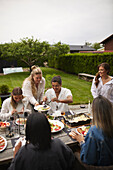 Friends having meal in garden