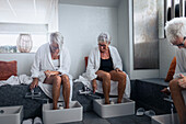 Senior women having footbath in spa