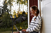 Smiling woman using laptop