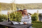 Smiling woman taking via phone