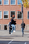 Teenager spielen Basketball auf dem Schulhof
