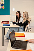 Teenage girls sitting in classroom