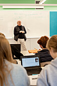 Teenage kids and teacher in classroom