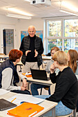 Teenage kids and teacher in classroom