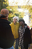 Smiling young friends talking outdoors