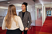 Business people talking in office corridor