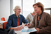 Businesswomen sitting together in business seminar