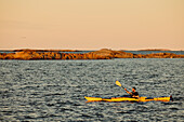 Man kayaking on sunny autumn day