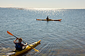 Men kayaking on sunny day