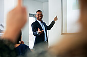 Businessman presenting before colleagues during meeting