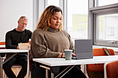 Business woman at workshop using digital tablet