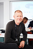 Portrait of young businessman sitting at desk