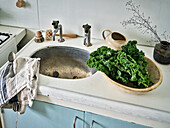 Kale in bowl at kitchen sink