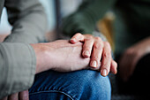 Close-up of man and woman touching hands