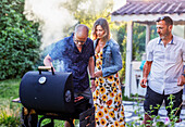 People having barbecue in garden