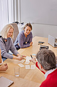 Smiling people talking during business meeting