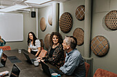 Smiling people talking during business meeting