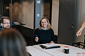 Smiling woman talking during business meeting